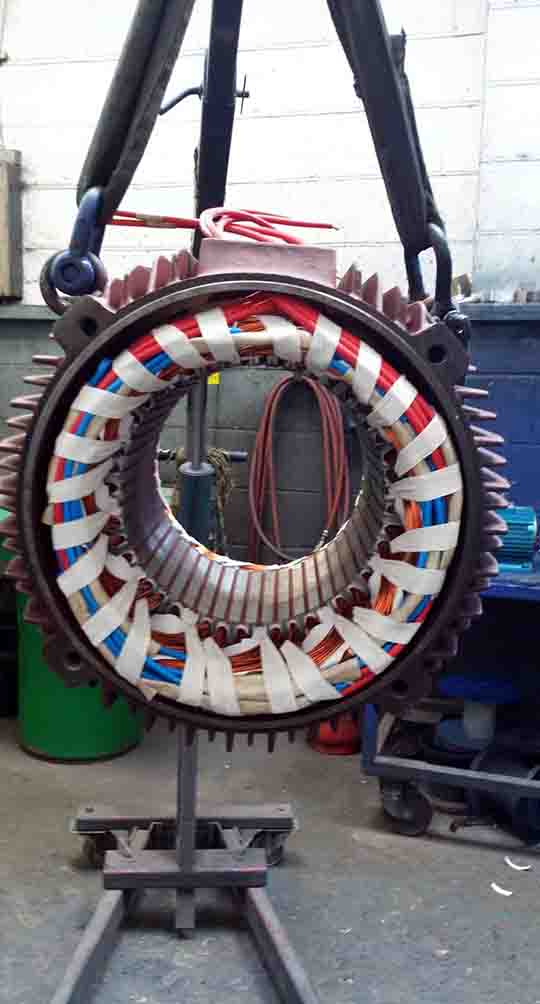 This image shows a multi-coloured 37KW Stator that has been restored